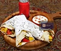 ساندویچ شاورما با مرغ و گوشت، پر از سبزیجات تازه و سس مخصوص