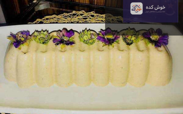 دسر کینگلی آیس مقوی و مجلسی مناسب ماه رمضان، با لایه های رنگارنگ و تزیین شده با میوه و پودر پسته